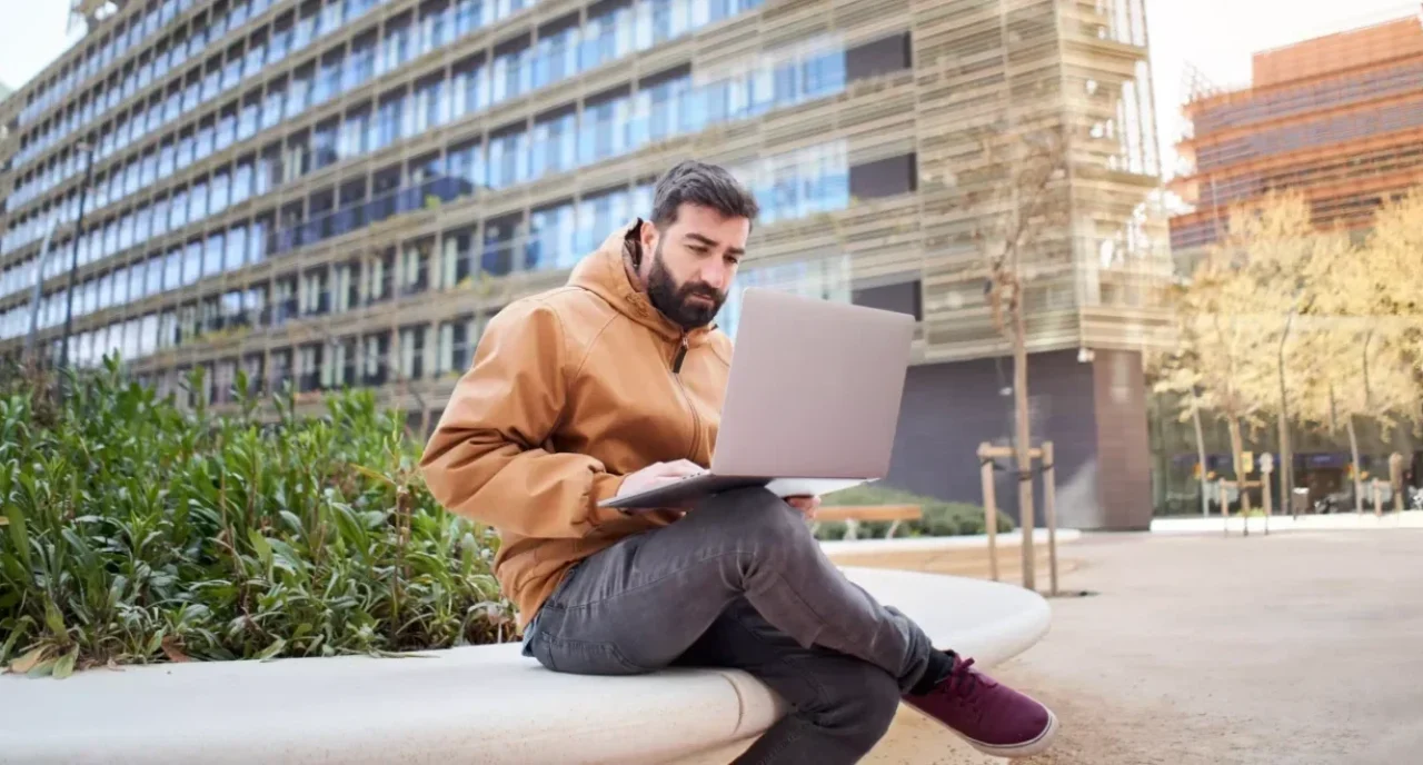 business-man-typing-on-laptop-computer-outdoors-2022-01-19-00-18-35-utc
